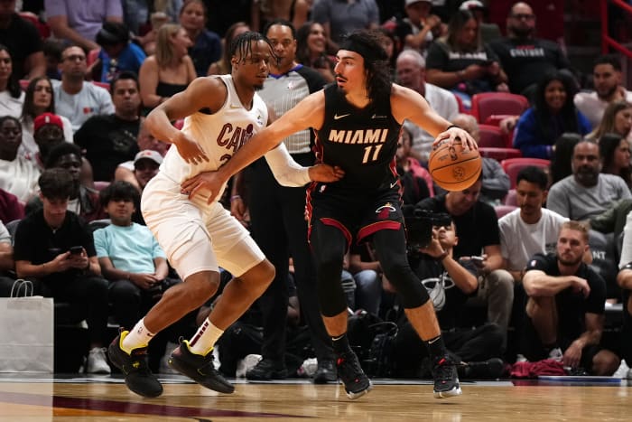 Dec 8, 2023; Miami, Florida, USA; Miami Heat guard Jaime Jaquez Jr. (11) dribbles the ball around Cleveland Cavaliers forward Isaac Okoro (35) during the second half at Kaseya Center.